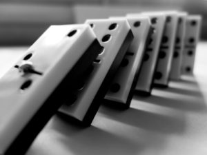 Monochromatic Image Of Dominoes Placed Standing Up In A Line Falling Over