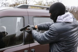 Thief In A Black Face Mask Pointing Firearm At Driver Window