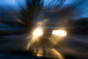 Blurred Vehicle With Headlights On At Night