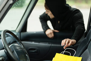 White Juvenile Male Thief In Black Hoodie Reaching For Item In Car Though Open Front Passanger Window