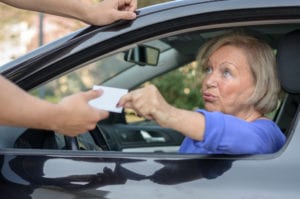 woman showing ID to police officer